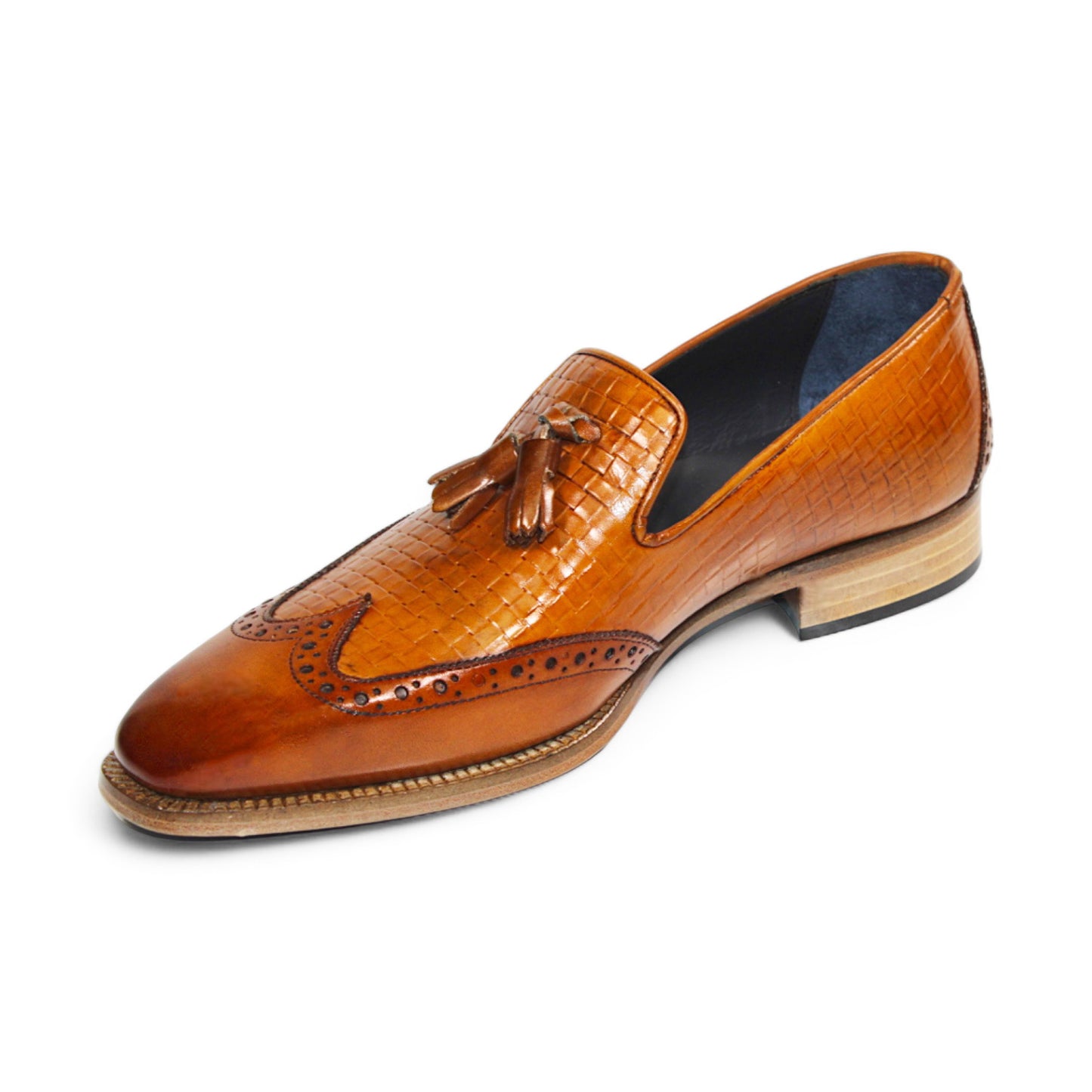 The Duca Di Matiste Cosenza (Cognac) loafer from Duca Di Matiste features Italian leather in a brown hue, a woven texture, front tassels, and a low stacked heel.