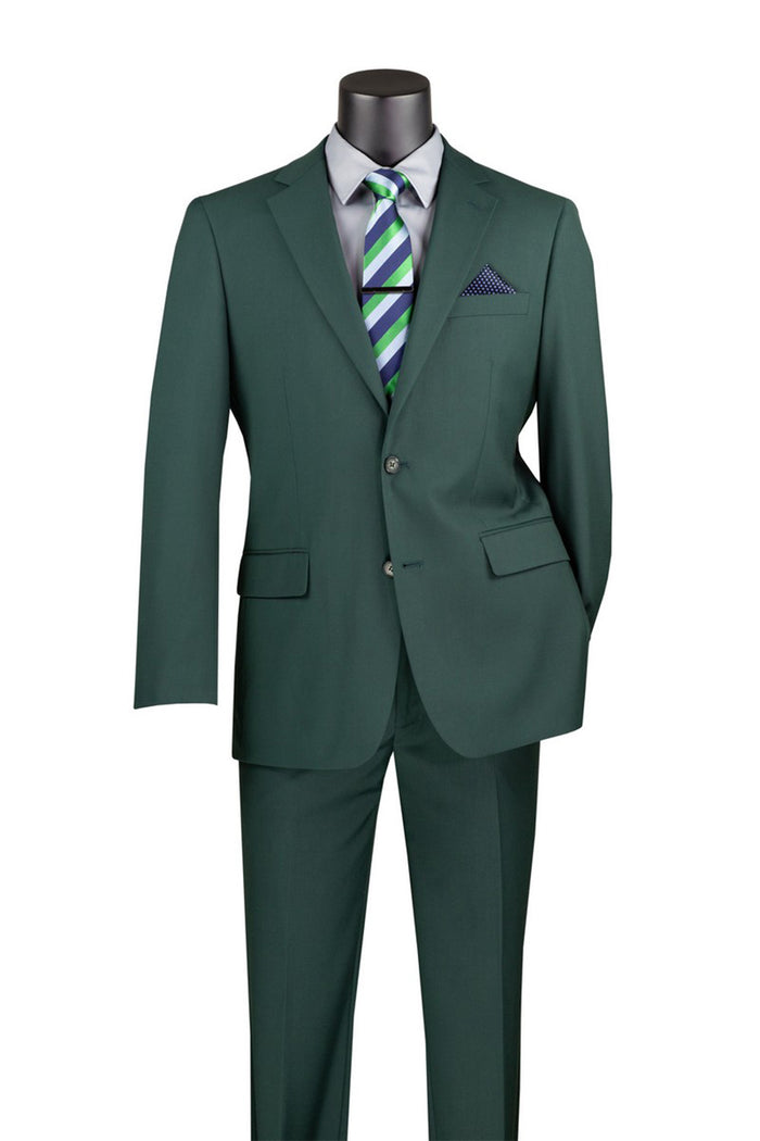 The Vinci Executive 2 Piece Suit in Hunter Green by Vinci Suits, featured on a mannequin, is complemented with a striped green and blue tie and a blue pocket square. This ensemble provides a luxurious wool feel that exudes sophistication.