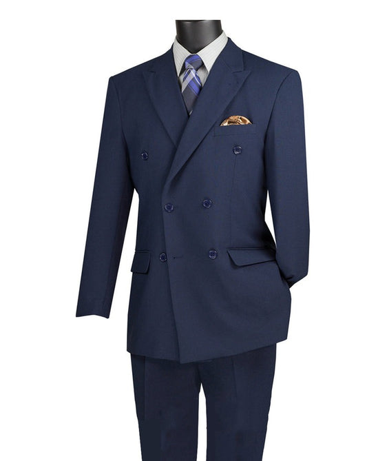 Displayed on a mannequin is the Vinci Suits regular fit double-breasted two-piece suit in navy, complete with a flexible elastic waistband, paired elegantly with a wrinkle-resistant striped shirt, blue tie, and highlighted by the addition of a pocket square.