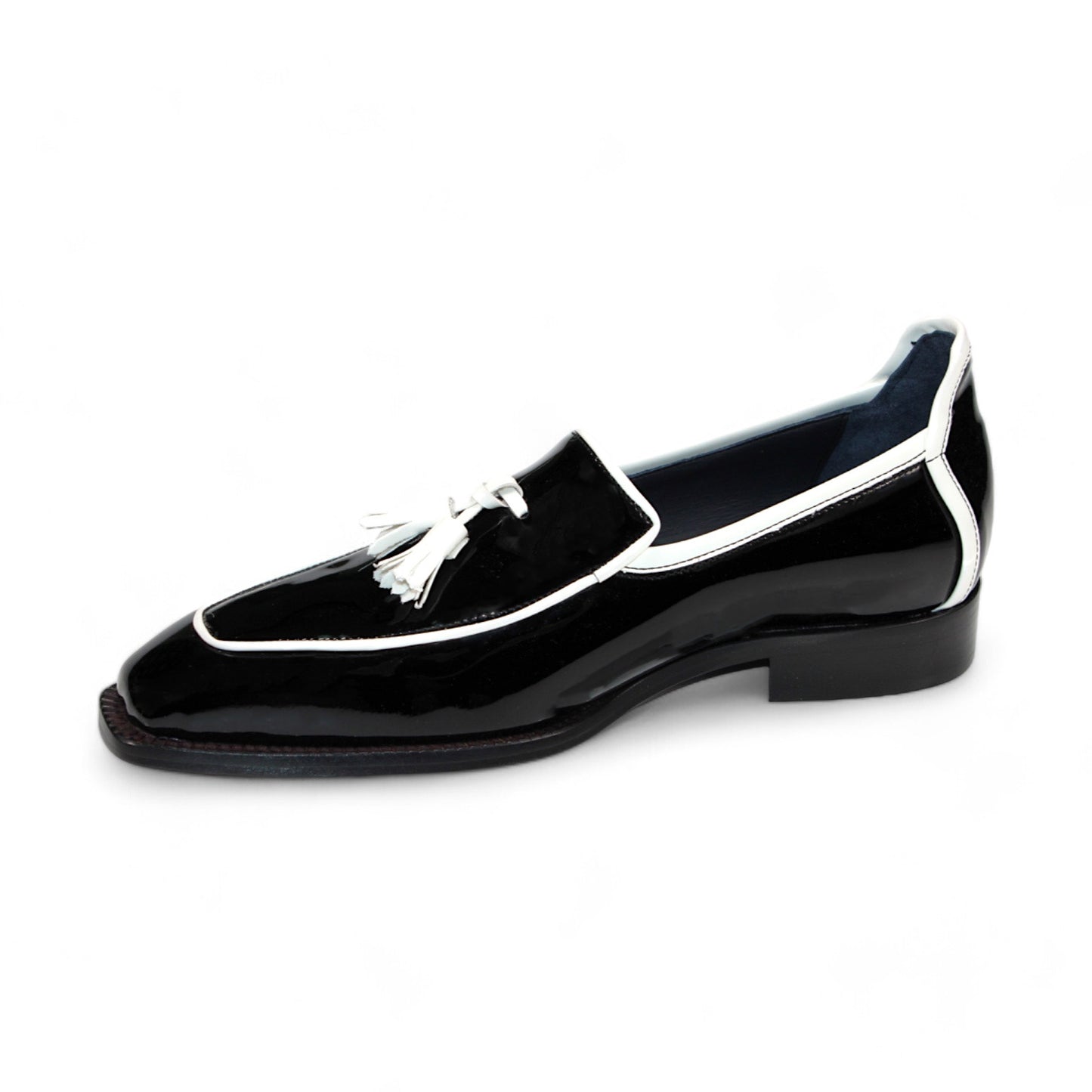 The Duca Di Matiste Fano loafer in black patent leather with white trim and tassel detailing, expertly crafted in Italy by Duca Di Matiste, is displayed against a pristine white background.