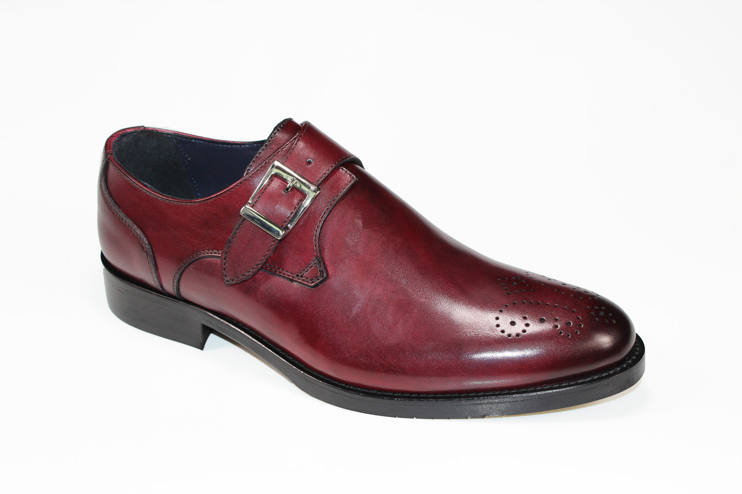 The Firmani Henry Bordo Shoe, a red leather dress shoe crafted in Italy featuring a decorative buckle and perforated toe design, is displayed against a white background.