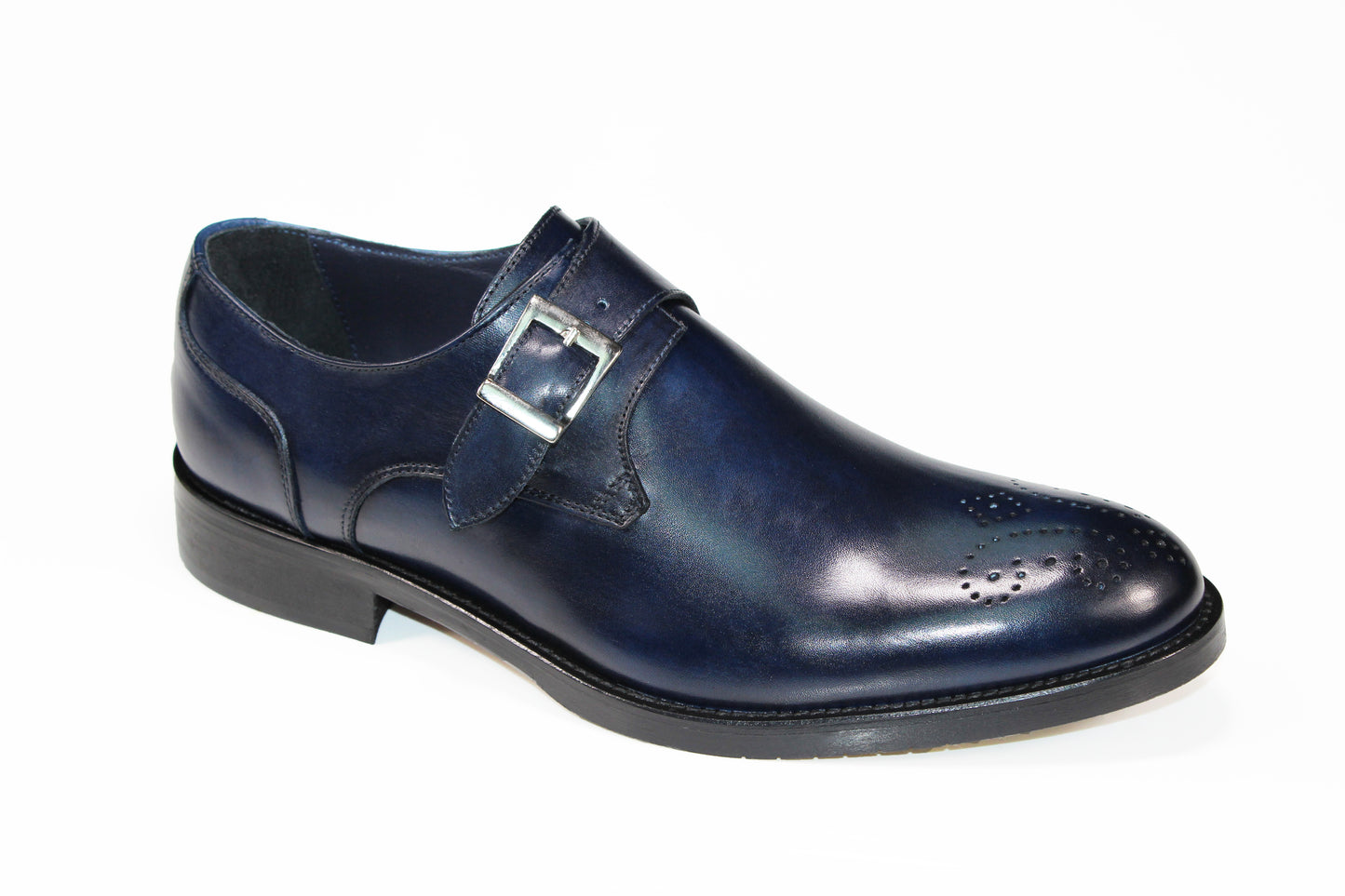 The Firmani Henry Navy Shoe from the brand Firmani is a single dark blue leather dress shoe, made in Italy, featuring a buckle strap and decorative perforations on the toe.