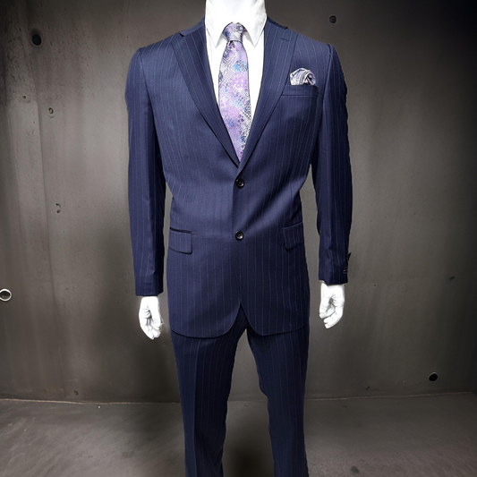 Displayed on the mannequin is the Tiglio Luxe Dolcetto Modern Fit Wool Suit in Blue Pinstripe, crafted from pure wool Italian fabrics. Complemented by a purple patterned tie and matching pocket square, it stands elegantly against a plain dark background.