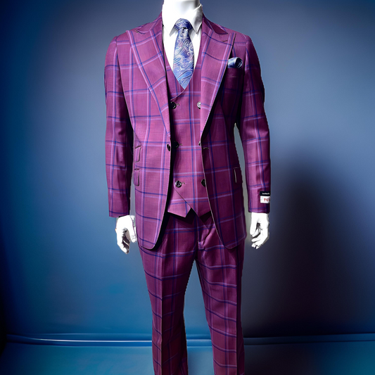 A mannequin features the Tiglio Rosso Orvietto Burgundy / Blue TL6333 suit, made from 100% wool, styled in a purple plaid three-piece ensemble and accessorized with a blue paisley tie, all displayed against a plain blue backdrop.