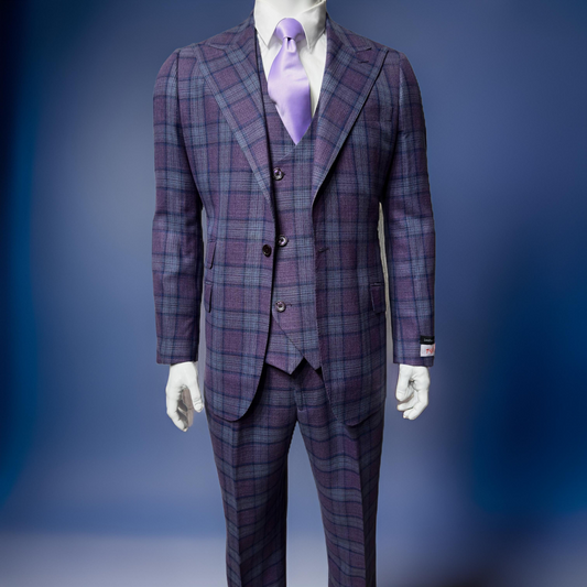 A stylish Tiglio Rosso Orvietto Lilac/Blue TL7510 three-piece suit, crafted from 100% wool, is displayed on a mannequin against a blue background.