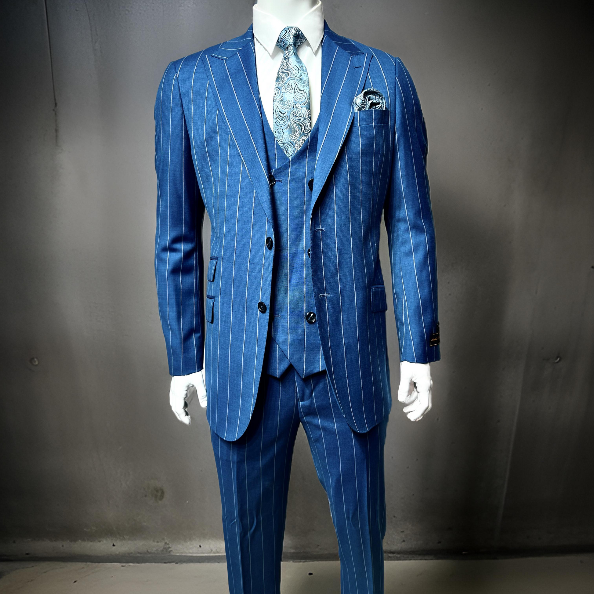 The mannequin is dressed in the Tiglio Luxe Prosecco Modern Fit teal blue/grey pinstripe suit crafted from pure wool, complete with a vest, white shirt, patterned tie, and pocket square, set against a plain gray background.