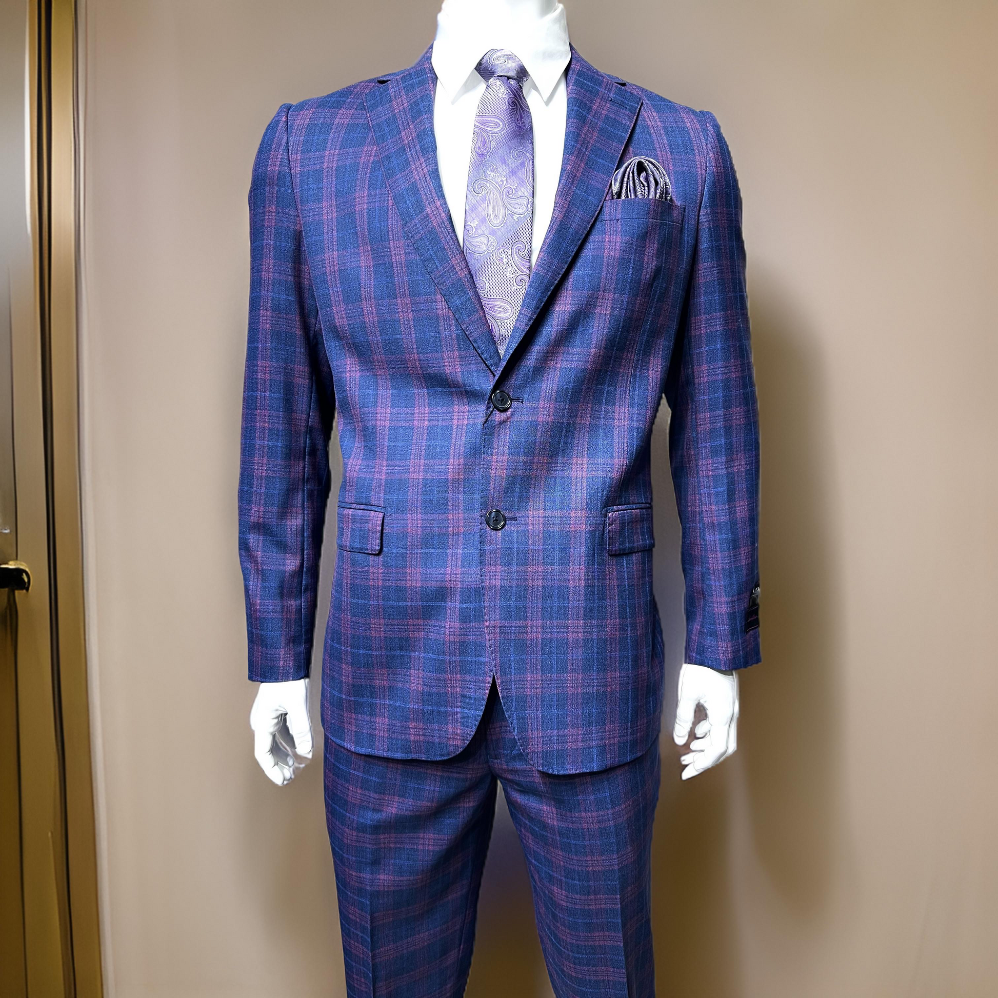 The mannequin is dressed in a Tiglio Luxe Dolcetto Modern Fit suit, TL4038, available in sizes 40S, 42S, and 44S, featuring a blue and purple plaid pattern crafted from pure wool. It is paired with a matching paisley tie and pocket square against a neutral background.