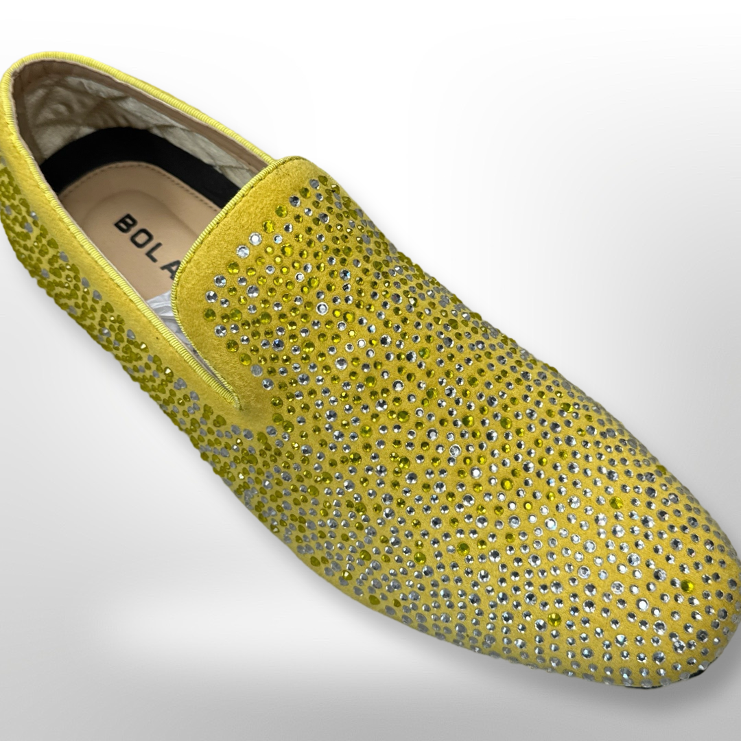 A Fiesso slip-on shoe, named Shoe 81 (SIZE 10 ONLY), decorated with silver rhinestones on a yellow background, is available as a final sale item.