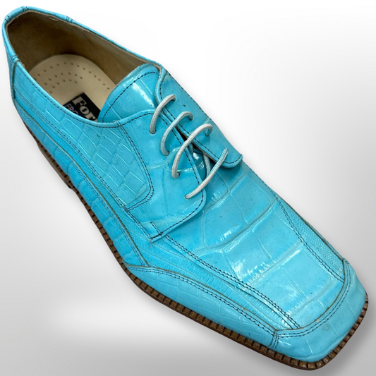 Introducing the Fiesso Shoe 73: a vibrant blue crocodile leather dress shoe in size 9.5, showcasing a square toe adorned with white laces, a distinctive textured pattern, and complemented by a brown sole. Please note that this item is FINAL SALE and cannot be returned or exchanged.