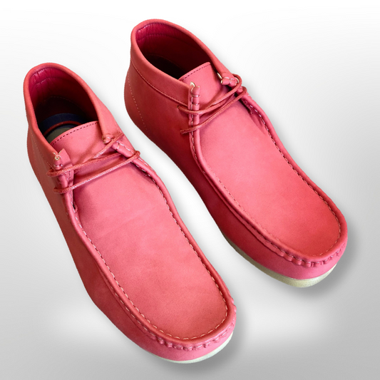 A pair of stylish, Unique Design Menswear's Amali Jason Chukka Boots in red with white soles on a light background.