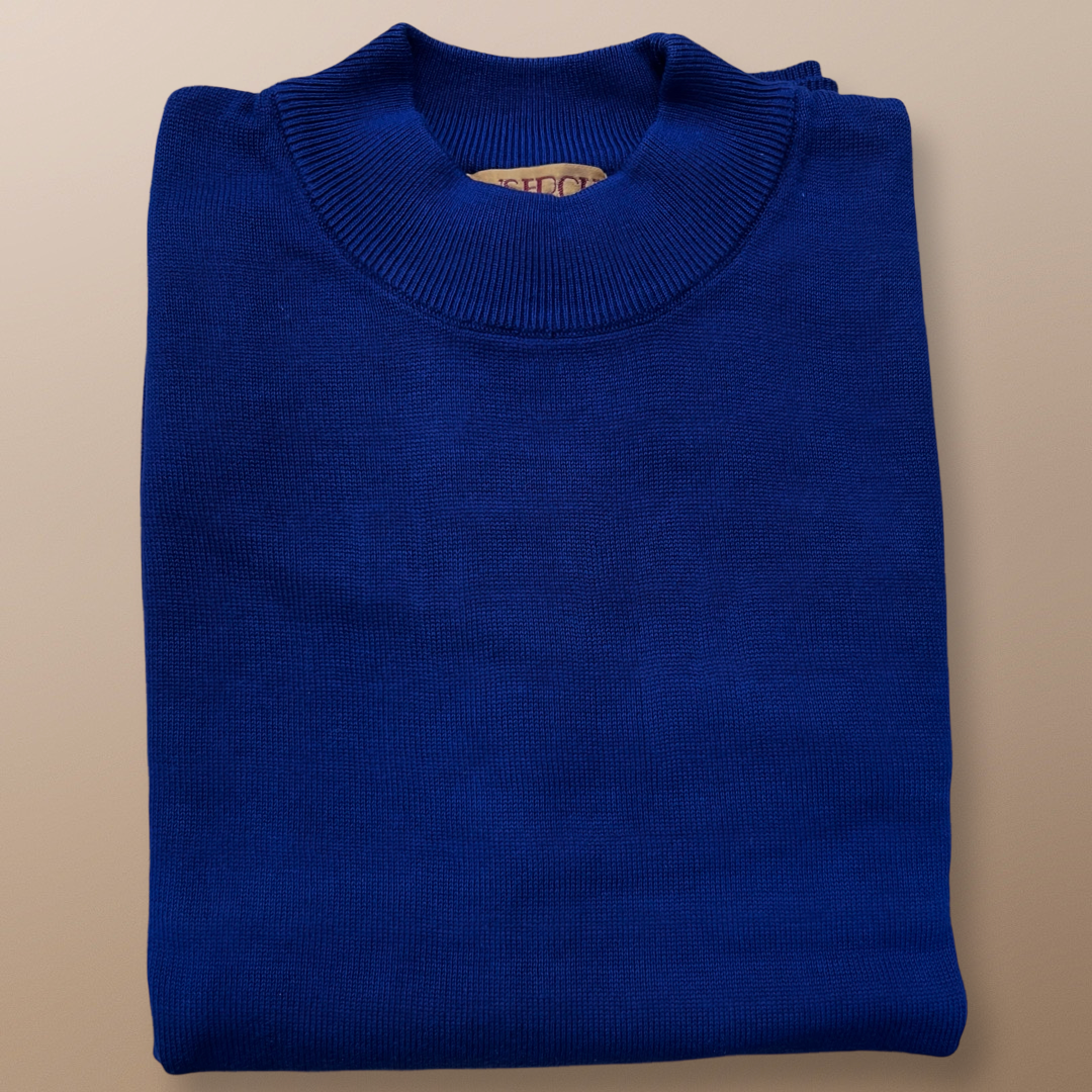 The Inserch Cotton Blend Mock Neck Sweater in River Blue elegantly rests against a beige background, highlighting its timeless style.