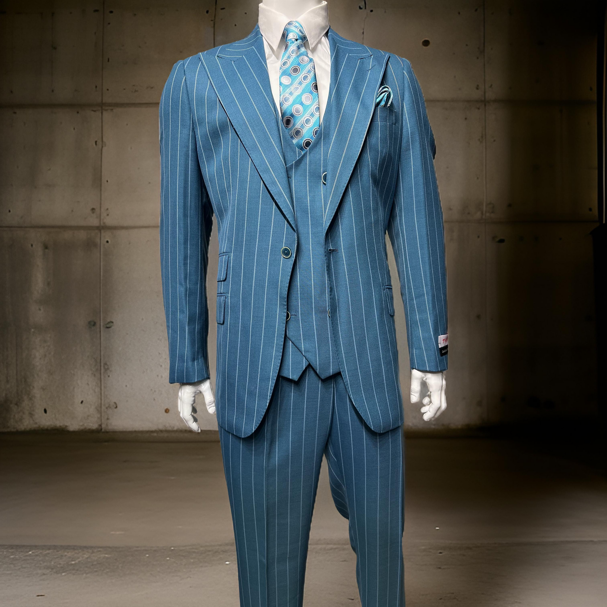 A mannequin showcases the Tiglio Rosso Orvietto Teal Blue Grey Pinstripe TL6019 suit, made from 100% wool, complemented by a matching tie and vest, standing against a concrete wall. This ensemble underscores the elegance of Tiglio Rosso suits.