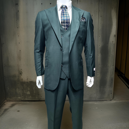 A mannequin wearing the Tiglio Rosso Orvietto Solid Hunter Green TL4186 three-piece suit, complete with a patterned tie, is displayed against a concrete wall backdrop.