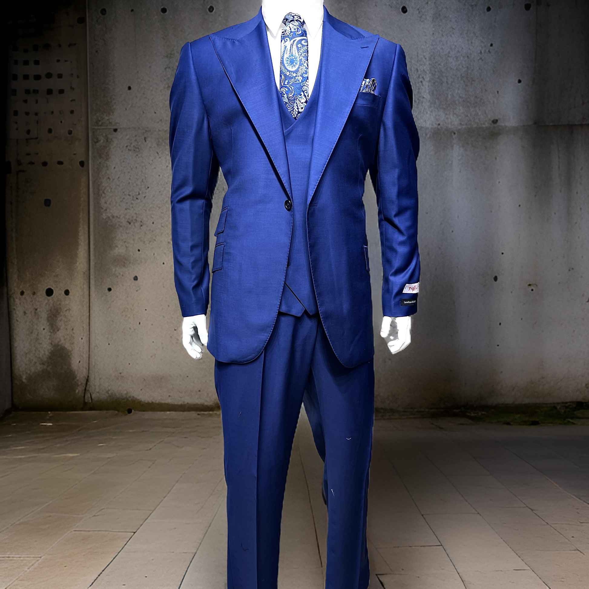 The Tiglio Rosso Orvietto Solid French Blue Single Pleat FBLUE, a sophisticated three-piece suit made from 100% wool, is gracefully showcased on a mannequin against a concrete wall.