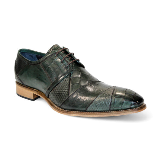 The rear view of the Duca Di Matiste Imperio in dark green showcases a leather dress shoe with an embossed crocodile design, paired with a wooden sole and textured pattern against a white background.