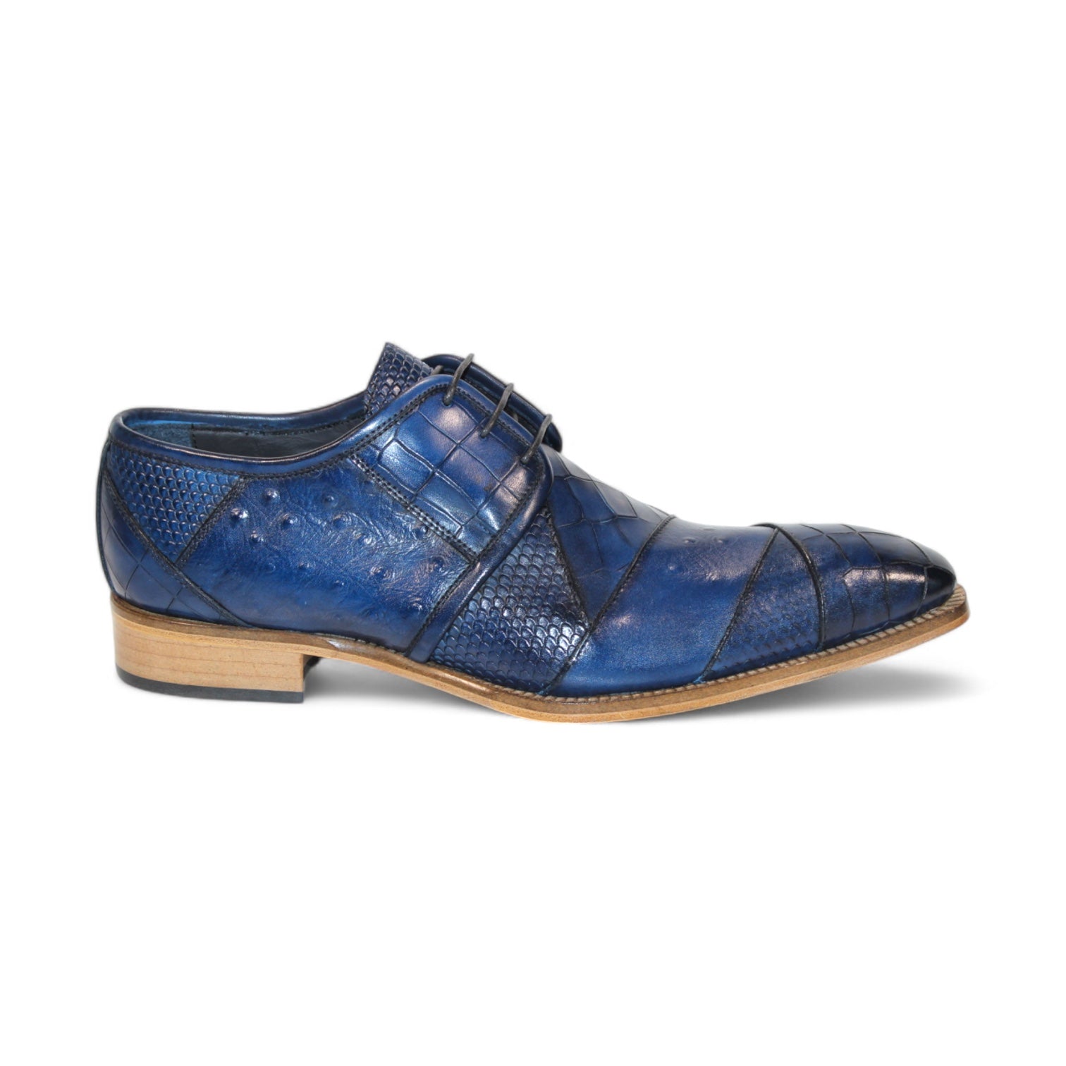 The Duca Di Matiste Imperio in Ocean Blue showcases a sophisticated leather dress shoe with an embossed crocodile pattern, complemented by a brown sole and black laces, viewed from the side. Crafted in Italy to add a touch of elegance.