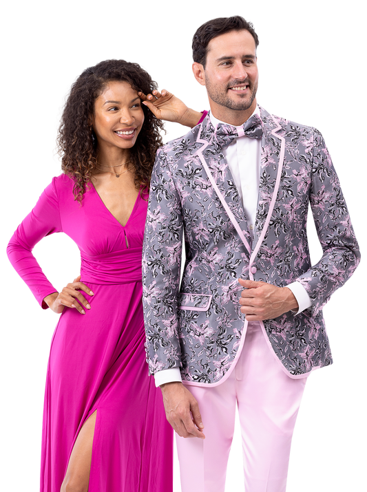 Two people stand together. The person on the left wears a pink gown, and the person on the right wears an EJ Samuel gray suit (JP129) with a bow tie.