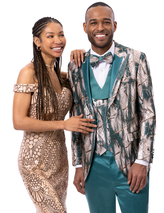 A smiling couple in formal attire: the woman stuns in a patterned off-shoulder dress while the man showcases the EJ Samuel Aqua Suit JP136 by EJ SAMUEL, complemented by a matching bowtie.