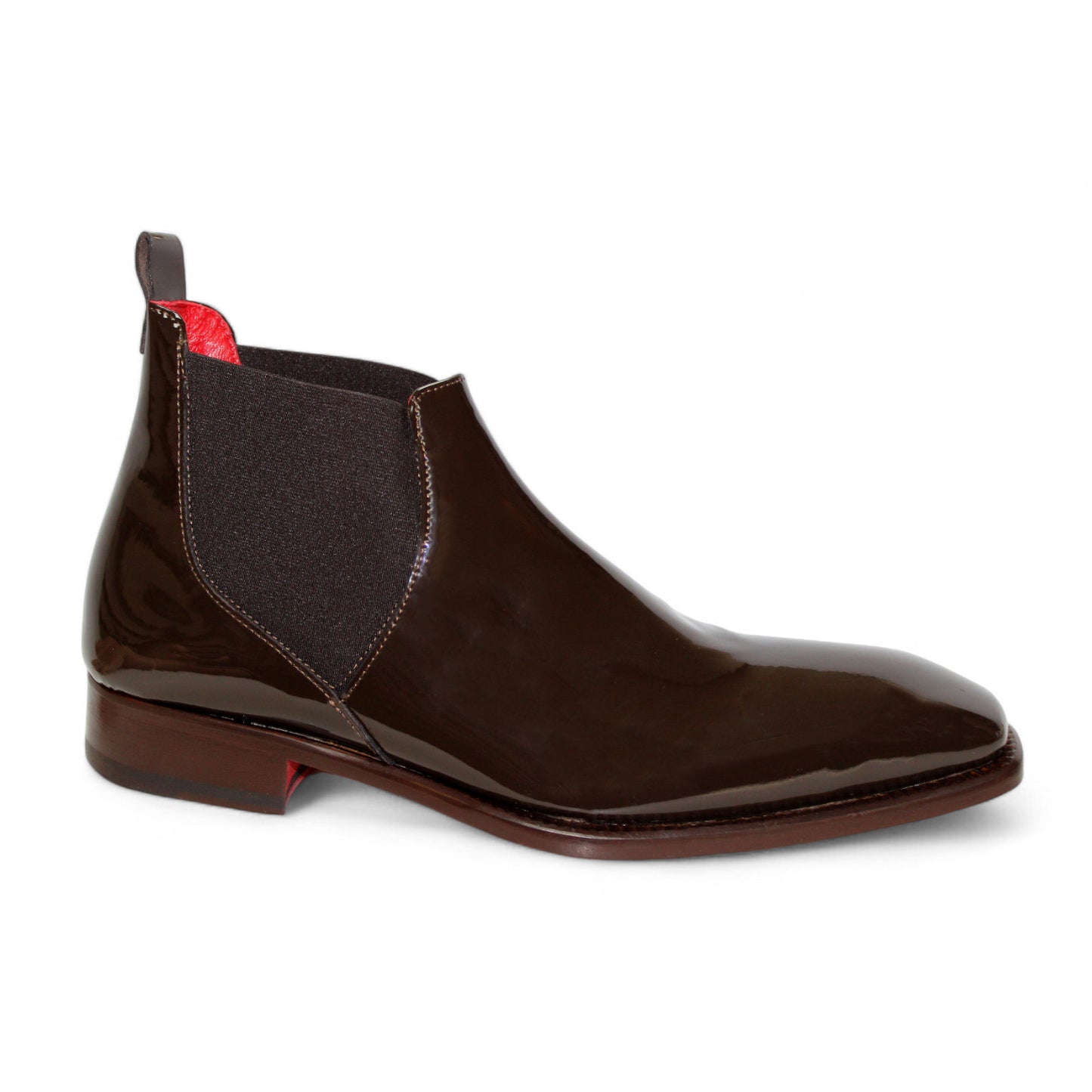 The Emilio Franco "Leonardo" Chocolate Boot is a glossy brown patent leather Chelsea boot featuring black elastic side panels and a brown sole, showcasing exquisite Italian craftsmanship in its side profile.