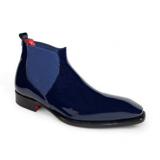 Introducing the Emilio Franco "Leonardo" Navy Boot, a stunning glossy dark blue Chelsea boot designed with patent leather and a vibrant red interior. It features an elastic side panel, a sleek low black heel, and a convenient pull tab. Crafted with precision and elegance, its durable leather bottom exemplifies classic Italian craftsmanship while ensuring unparalleled style.