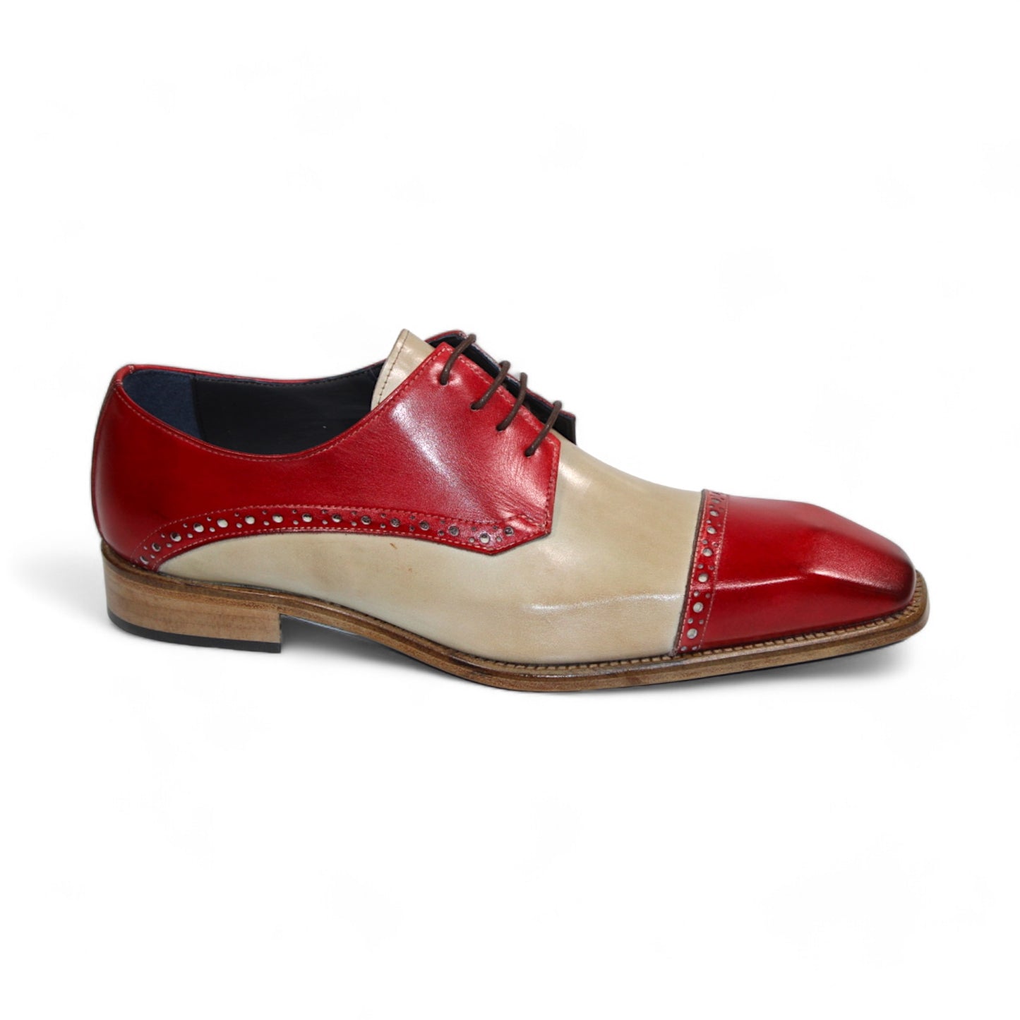 The Duca Di Matiste Lombardi is a men's dress shoe made in Italy, featuring red and beige leather with decorative perforations, a square toe, and a low wooden heel.