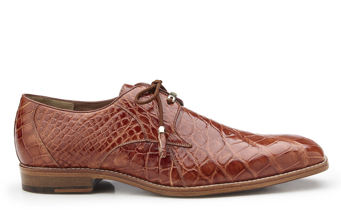 The Belvedere - Lago, a genuine alligator dress shoe in Cognac, style number 14010, boasts a luxurious crocodile pattern with lace-up closure and leather lining. It's an ideal choice for menswear shoes enthusiasts and is presented in a side profile. Available in-store from BELVEDERE.