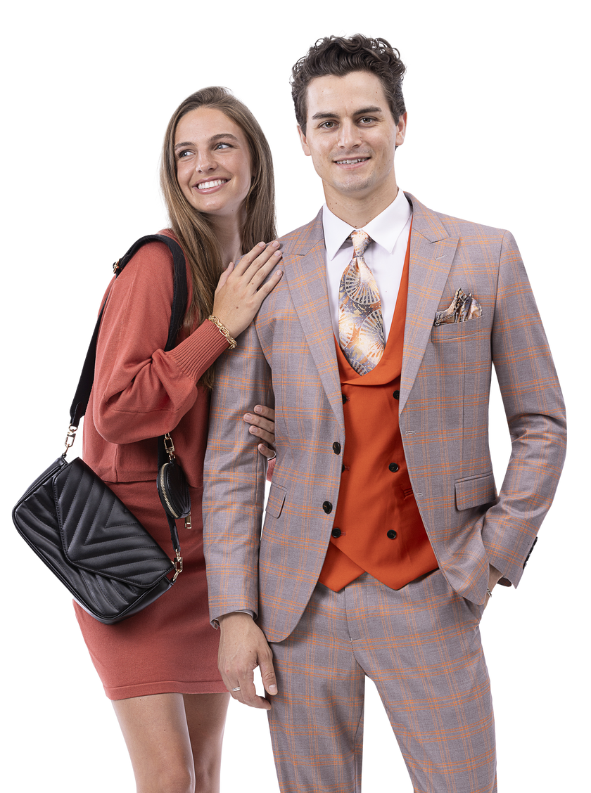 A woman in a rust-colored dress stands smiling next to a man wearing the EJ Samuel Taupe Suit M2797, complete with an orange vest. The woman carries a black quilted bag, and the man completes his look with a patterned tie from his 3-piece suit by EJ SAMUEL.