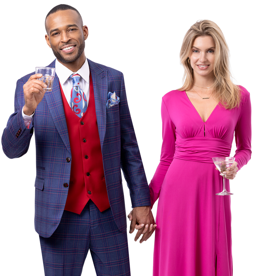 A man dressed in the EJ Samuel Navy/Red Suit M2802 by EJ SAMUEL and a woman in a pink dress hold hands, each holding a cocktail in their other hand.