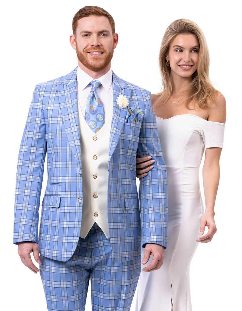 A gentleman wearing the EJ Samuel Blue Suit M2803 paired with a cream vest stands beside a woman in an elegant white off-shoulder dress, perfectly embodying style and sophistication.