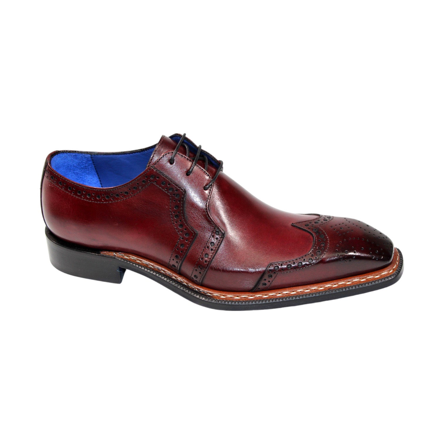 Emilio Franco "Marco" shoes feature a lustrous burgundy leather with intricate brogue detailing and a blue inner lining, showcasing the timeless craftsmanship of being Made in Italy.