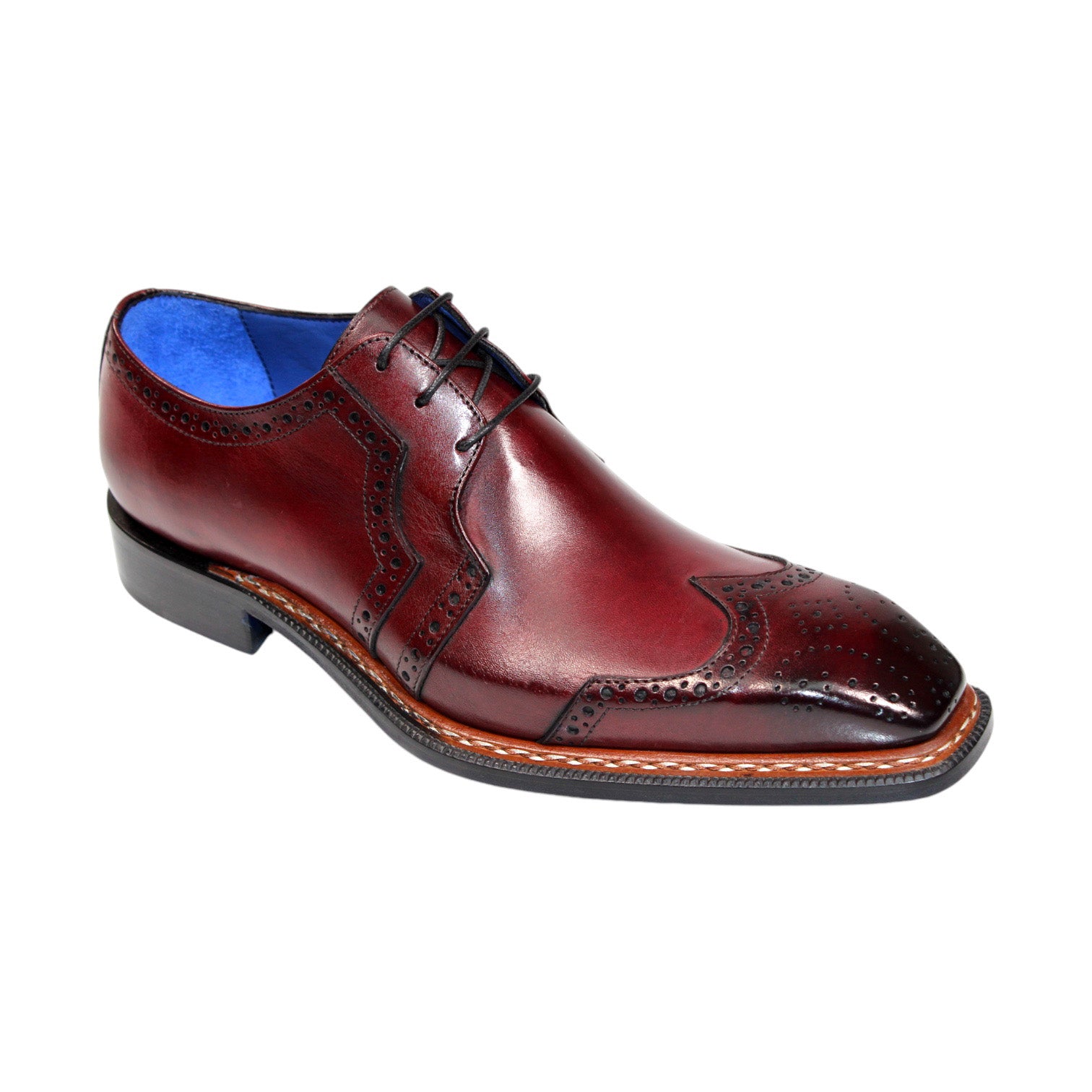 Emilio Franco "Marco" shoes feature a lustrous burgundy leather with intricate brogue detailing and a blue inner lining, showcasing the timeless craftsmanship of being Made in Italy.