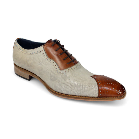 The Duca Di Matiste Marino (Cognac/Neutro) brogue shoe by Duca Di Matiste is expertly crafted from brown and beige leather, featuring intricate stitching, laces, and embossed snake leather details. Made in Italy.