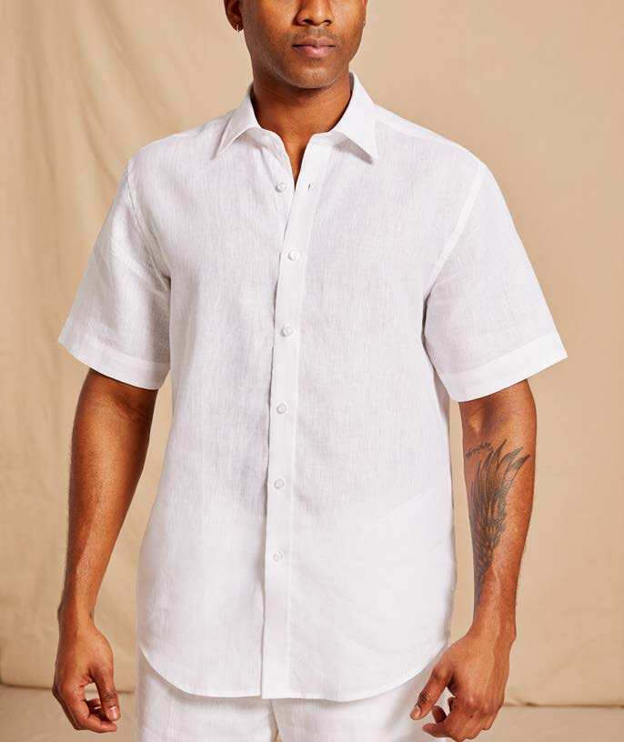 Person wearing an Inserch Premium Linen Yarn Dye Short Sleeve Shirt SS717-02, showcasing its European flax linen texture, stands against a plain background.