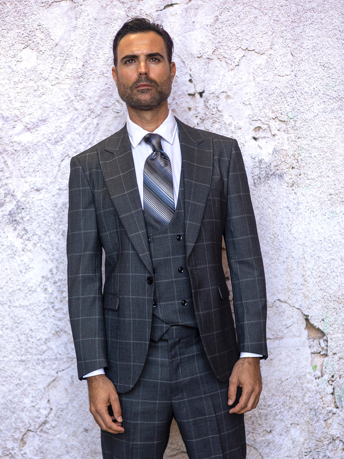 A man in an INSOMNIA MGM 3PC Tailored Fit Charcoal Suit.