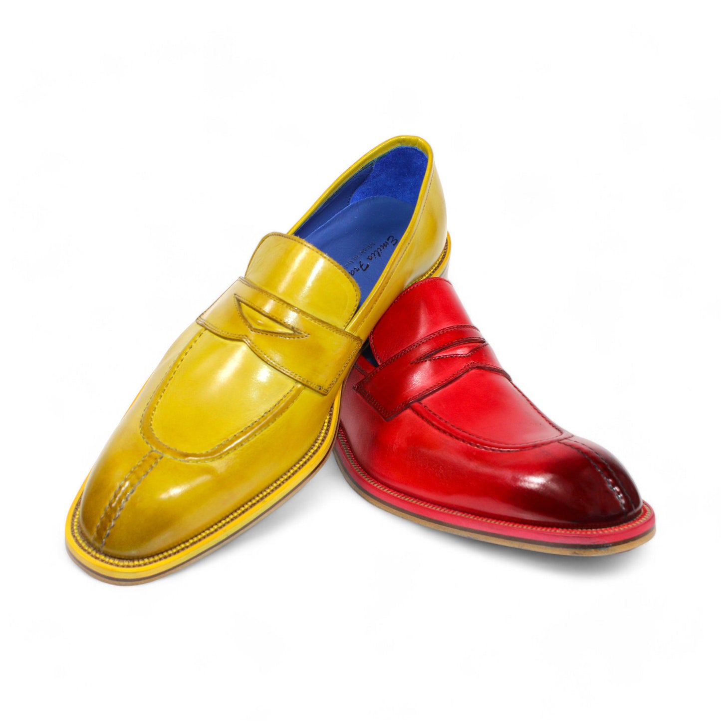 The Emilio Franco "Mirko" Yellow Shoes, made from Italian leather, feature one yellow and one red loafer with blue interiors, elegantly arranged overlapping against a white background.