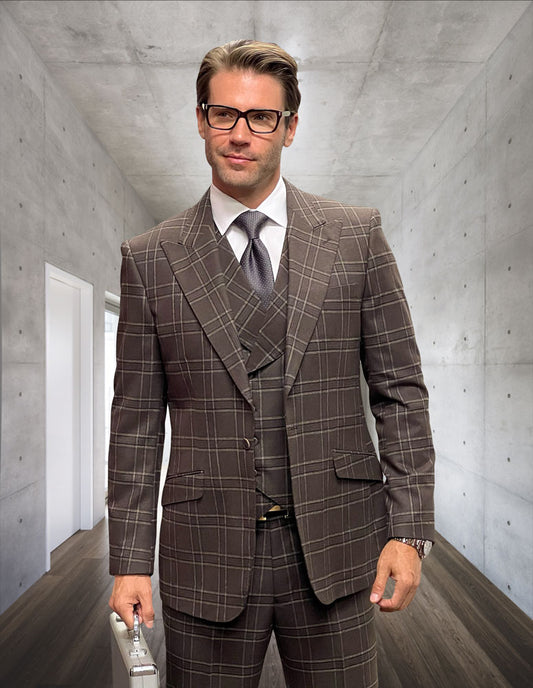 A man in a MONARI-BROWN suit by Statement Clothing, made from Italian wool, stands with his briefcase in a sleek, modern concrete hallway.