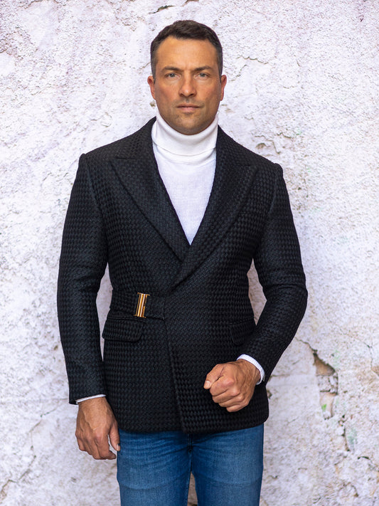 An individual wearing the INSOMNIA MZS-567 Tailored Fit Black Fancy Sport Coat and a white turtleneck stands in front of a light, textured wall.