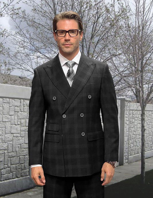 A man in the sophisticated STATEMENT CLOTHING | NAPLES-BLACK suit and glasses stands confidently in front of a stone wall and bare trees, highlighting the elegance of Italian wool from Statement Clothing.