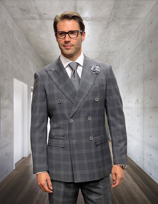 A man wearing the Naples-Gray double-breasted suit from Statement Clothing, made of Italian wool, and glasses stands in a concrete hallway.