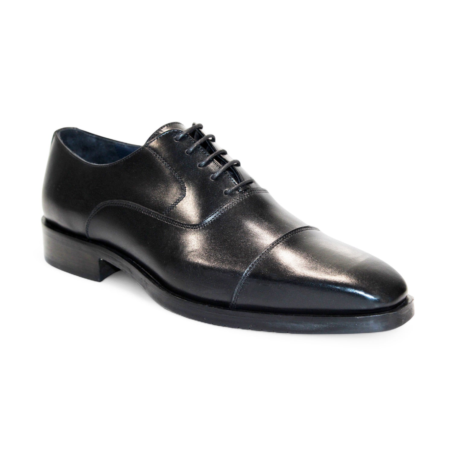 The Firmani Owen Black Shoes feature a solitary black leather dress shoe with laces, highlighting a cap toe design and low heel, as seen from the side. Masterfully crafted in Italy by Firmani, it represents timeless elegance and expert craftsmanship.