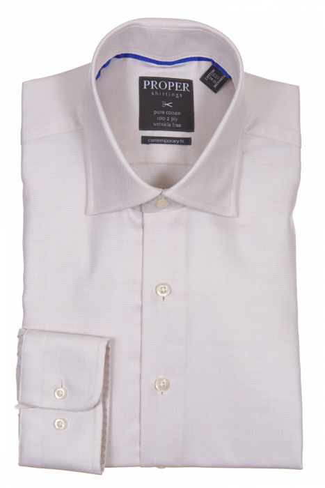 A folded tan dress shirt made from cotton, featuring a pointed collar and front buttons, includes a Proper Shirtings label inside the collar and showcases a contemporary fit for a sleek look.