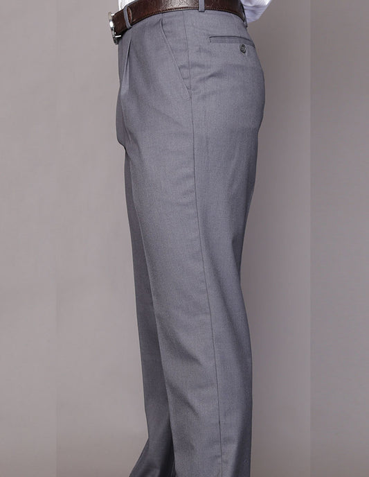 A person wearing Statement Clothing's regular fit pleated pants, model PA-200A-Charcoal, made from luxurious Super 150's wool with a brown belt, stands in profile against a plain background.