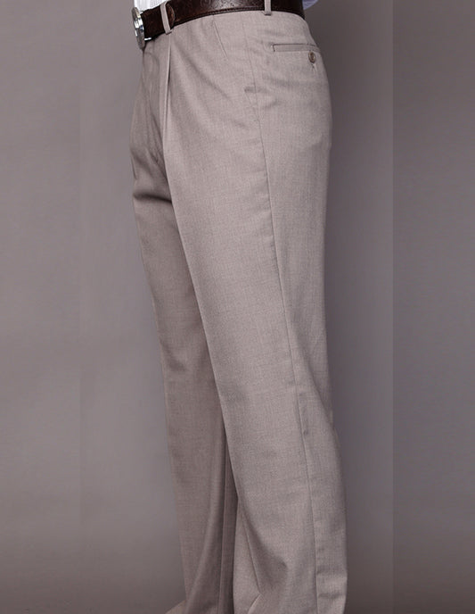 Side view of a person wearing Statement Clothing's Regular Fit Pleated Pants PA-200A-TAN in beige, made from Super 150's wool, paired with a brown belt against a plain background.