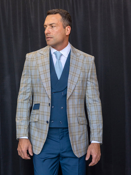 A man wearing the INSOMNIA PARIS-1 3PC Compose Tailored Fit Ash Suit stands against a black curtain, composing himself as he looks to his left.