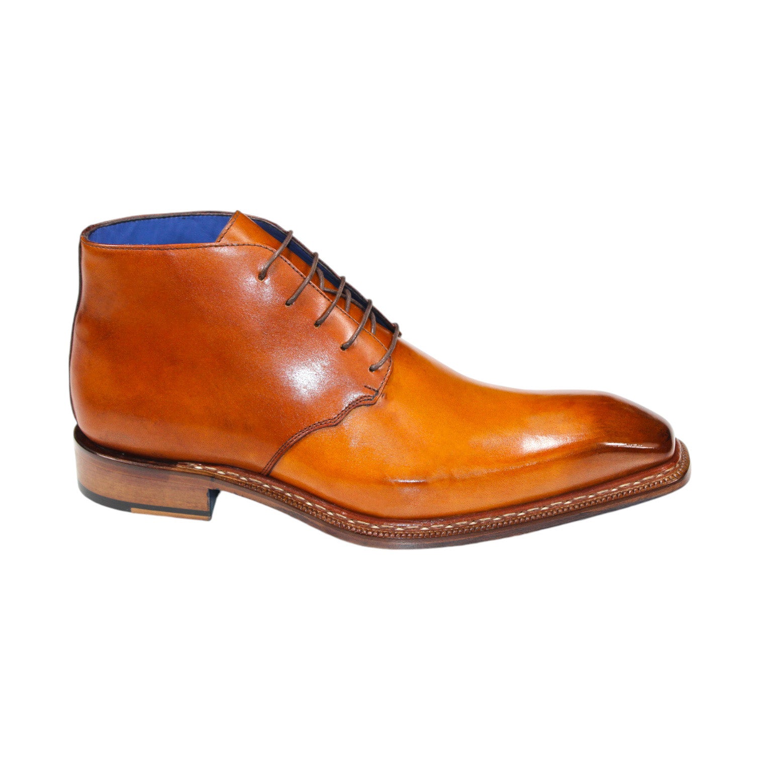 The Emilio Franco "Rocco" Gold Boot, a men's dress boot crafted from tan leather in Italy, showcases a blue interior lining and brown laces. It features a square toe and a low heel.