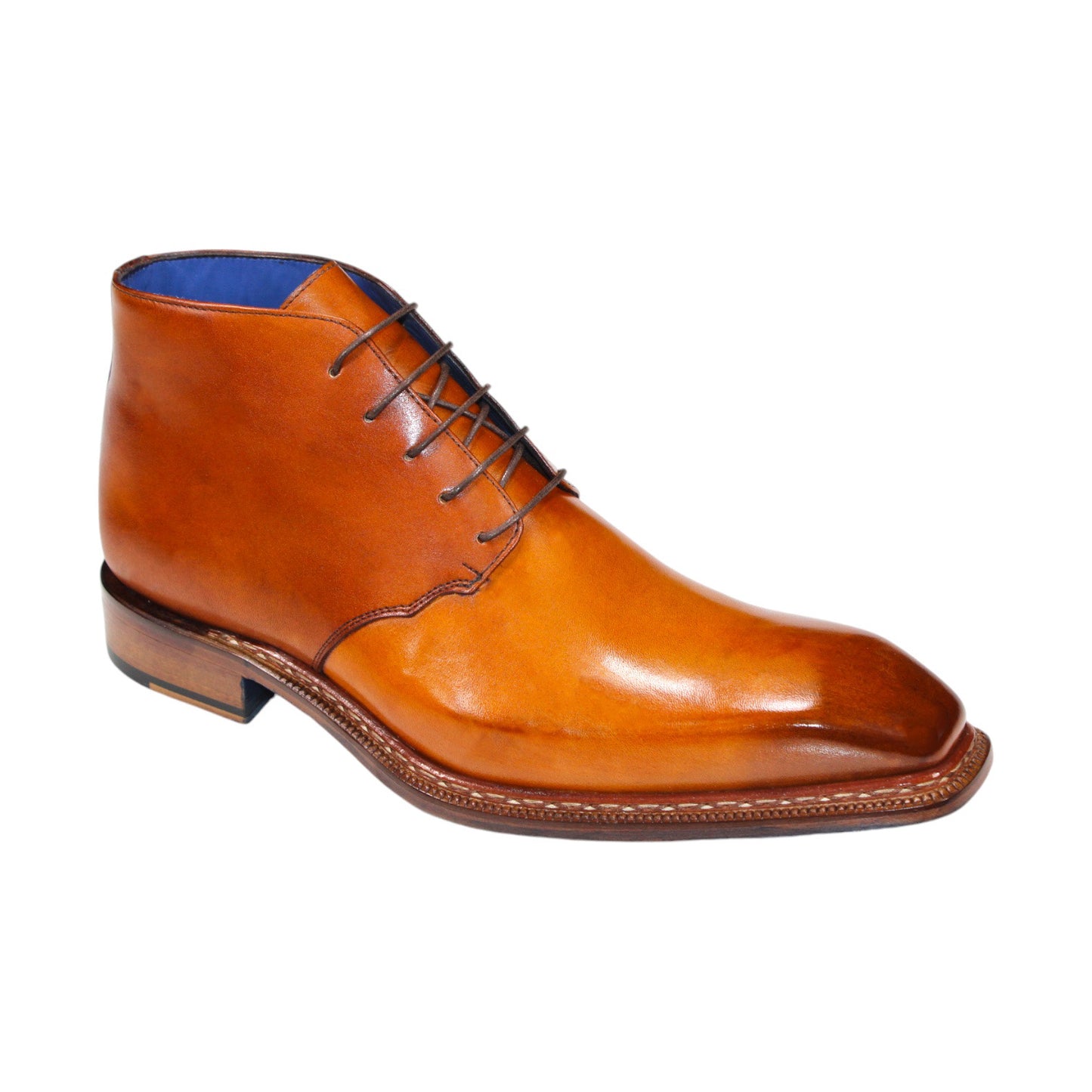 The Emilio Franco "Rocco" Gold Boot, a men's dress boot crafted from tan leather in Italy, showcases a blue interior lining and brown laces. It features a square toe and a low heel.