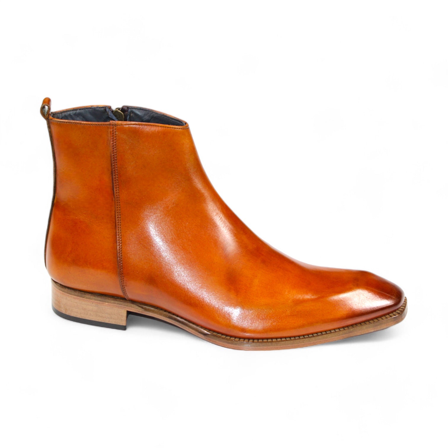 The Duca Di Matiste Romano (Gold) is a brown leather ankle boot with a polished finish and a low wooden heel, crafted from genuine leather. Made in Italy by Duca Di Matiste, these boots offer timeless style and unmatched quality.