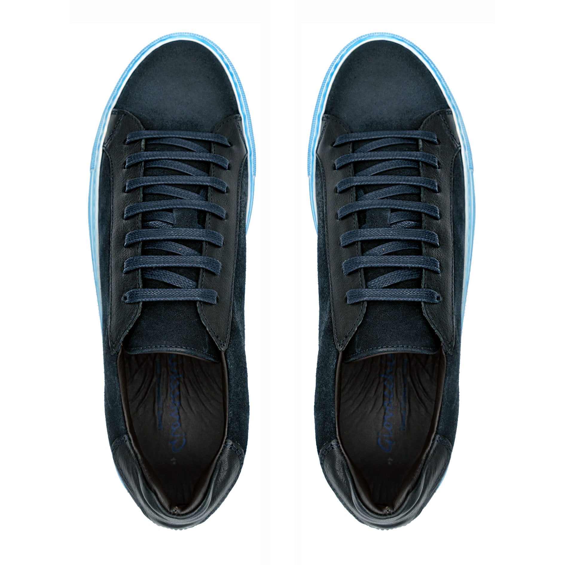 The GIOVACCHINI Rino Antique Blue Suede Calf Sneakers are designed with a sleek black exterior complemented by a blue sole and black laces, featuring a low-top silhouette and expertly crafted in Italy, all showcased against a white background.