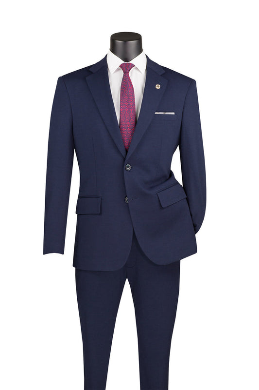 The Vinci Suits Slim Fit 2 Piece Suit, in navy SDX-3 with stretch fabric and an adjustable waistband, is elegantly displayed on a mannequin, paired with a white shirt and red tie.