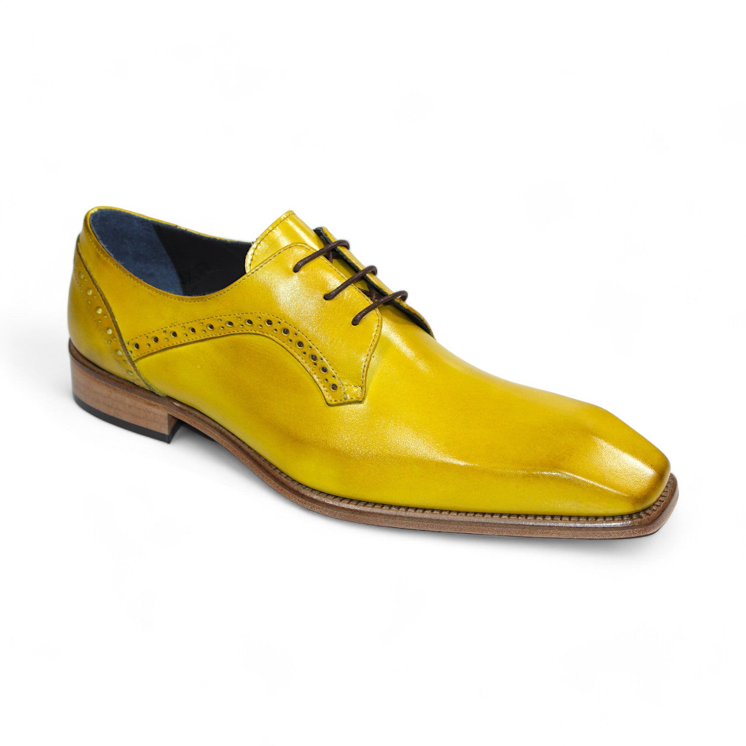 The Duca Di Matiste Spada in yellow is a leather dress shoe featuring brown laces and a wooden heel, adorned with decorative perforations along the sides. Crafted in Italy, these shoes exemplify an ideal combination of craftsmanship and elegance.